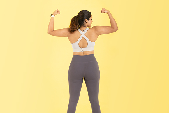 A woman wearing a posture bra, showcasing improved back support and comfort while maintaining a stylish appearance.