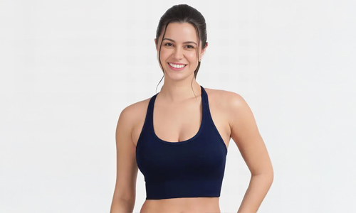 Woman in an ocean blue racerback seamless sports bra, showcasing comfort and style during their workout sessions.