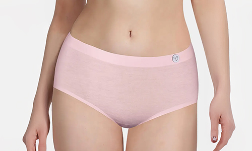 A woman models pink seamless underwear briefs, showcasing a smooth and comfortable design.