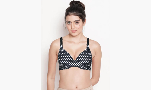 A woman wearing a black and white polka dot bra top, showcasing a stylish and comfortable design.