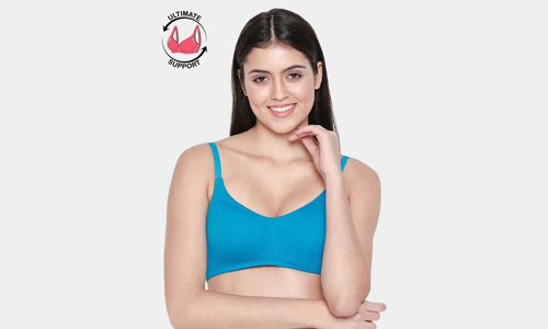 A woman models a trendy blue bra top, exuding confidence and showcasing her bold fashion choice.