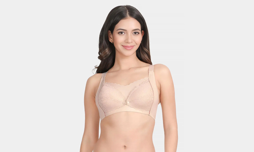 A woman in a nude bra top, showcasing a comfortable and stylish nude nursing bra for everyday wear.