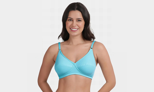 A woman confidently poses in a stylish blue bra, showcasing her vibrant fashion sense and self-expression.